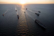(Sept. 4, 2022) From left, The Norwegian Fridtjof Nansen-class frigate HNoMS Roald Amundsen (F331), the U.S. Navy San Antonio-class amphibious transport dock ship USS Arlington (LPD 24), the Norwegian replenishment oiler HNoMS Maud (A530), the U.S. Navy Wasp-class amphibious assault ship USS Kearsarge (LHD 3), the Portuguese Vasco Da Gama-class frigate NRP Corte-Real (F332), the Royal Netherlands Navy multi-mission support ship HNLMS Karel Doorman (A 833), the U.S. Navy Whidbey Island-class dock landing ship USS Gunston Hall (LSD 44), and the U.S. Navy Arleigh Burke-class destroyer USS Paul Ignatius (DDG 117), sail in formation during a maneuvering exercise Sept. 4, 2022. The Kearsarge Amphibious Ready Group and embarked 22nd Marine Expeditionary Unit, under the command and control of Task Force 61/2, is on a scheduled deployment in the U.S. Naval Forces Europe area of operations, employed by U.S. Sixth Fleet to defend U.S., allied and partner interests. (U.S. Navy photo by Mass Communication Specialist 2nd Class Jesse Schwab)