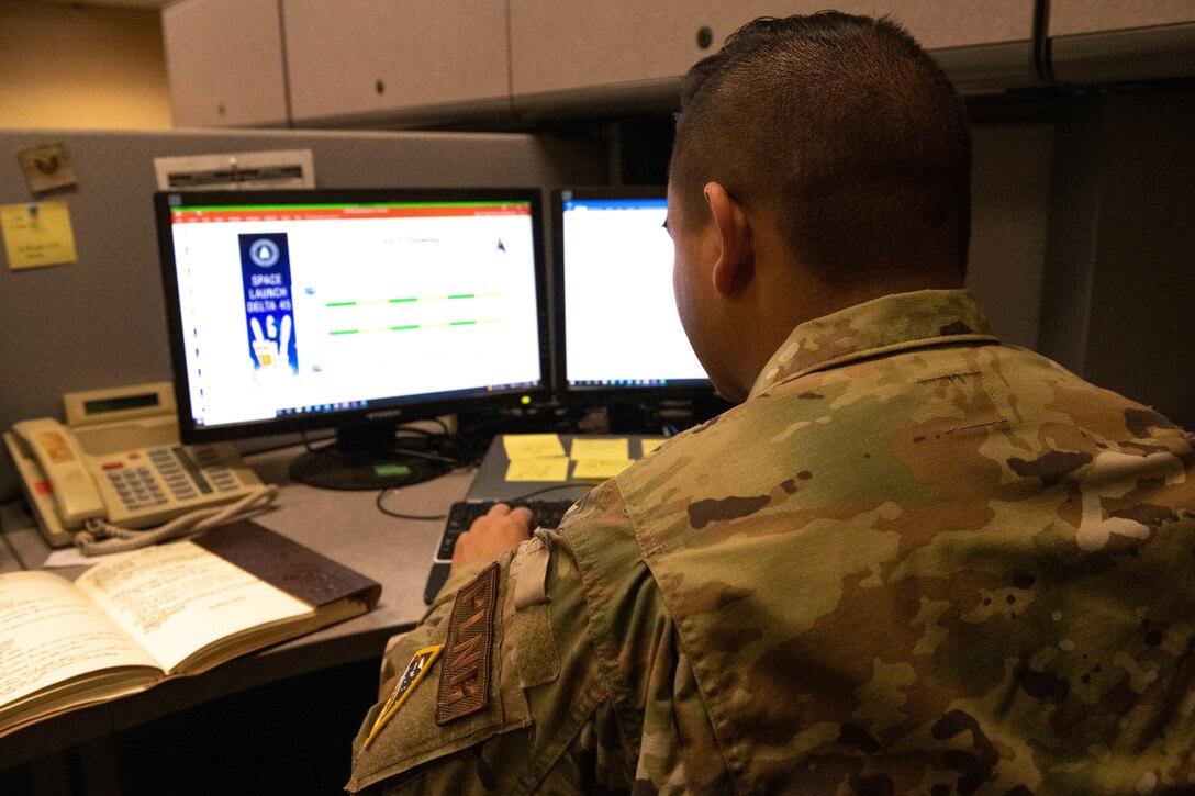 U.S. Air Force Staff Sgt. Eli Haley, 45 Logistics Readiness Squadron Non Commissioned Officer In Charge of plans and programs, works at his desk on Patrick Space force Base, Aug. 11, 2022. While managing all incoming Airmen and Guardians downrange, Logistic Plans also coordinate the movement of deployed personnel back to their home station. (U.S. Space Force photo by Senior Airman Samuel Becker)