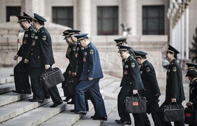 Chinese People’s Liberation Army members and military delegates arrive at Great Hall of the People