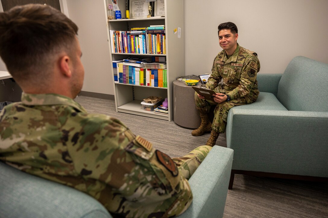 An airman speaks to another airman.