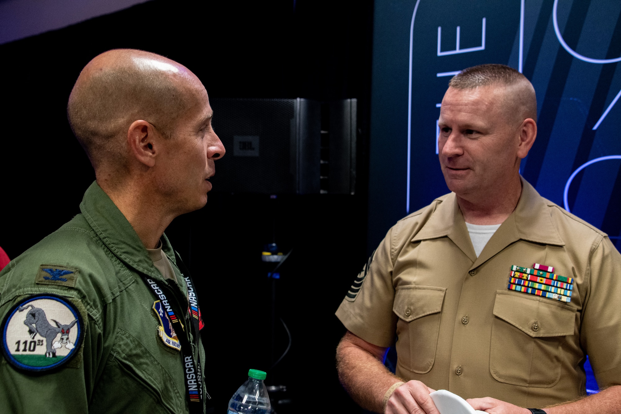 U.S. Air Force Col. Matthew Calhoun, 131st Bomb Wing commander, greets U.S. Marine Corps Sgt. Maj. Mark Murphy, member with the Combat Logistics Regiment 4, at the 1948 club at the Kansas Speedway in Kansas City, Kansas, Sept. 11, 2022. Leaders and Airmen accompany ground crews to flyovers to represent Team Whiteman and tell the Air Force story. (U.S. Air National Guard photo by Airman 1st Class Phoenix Lietch)