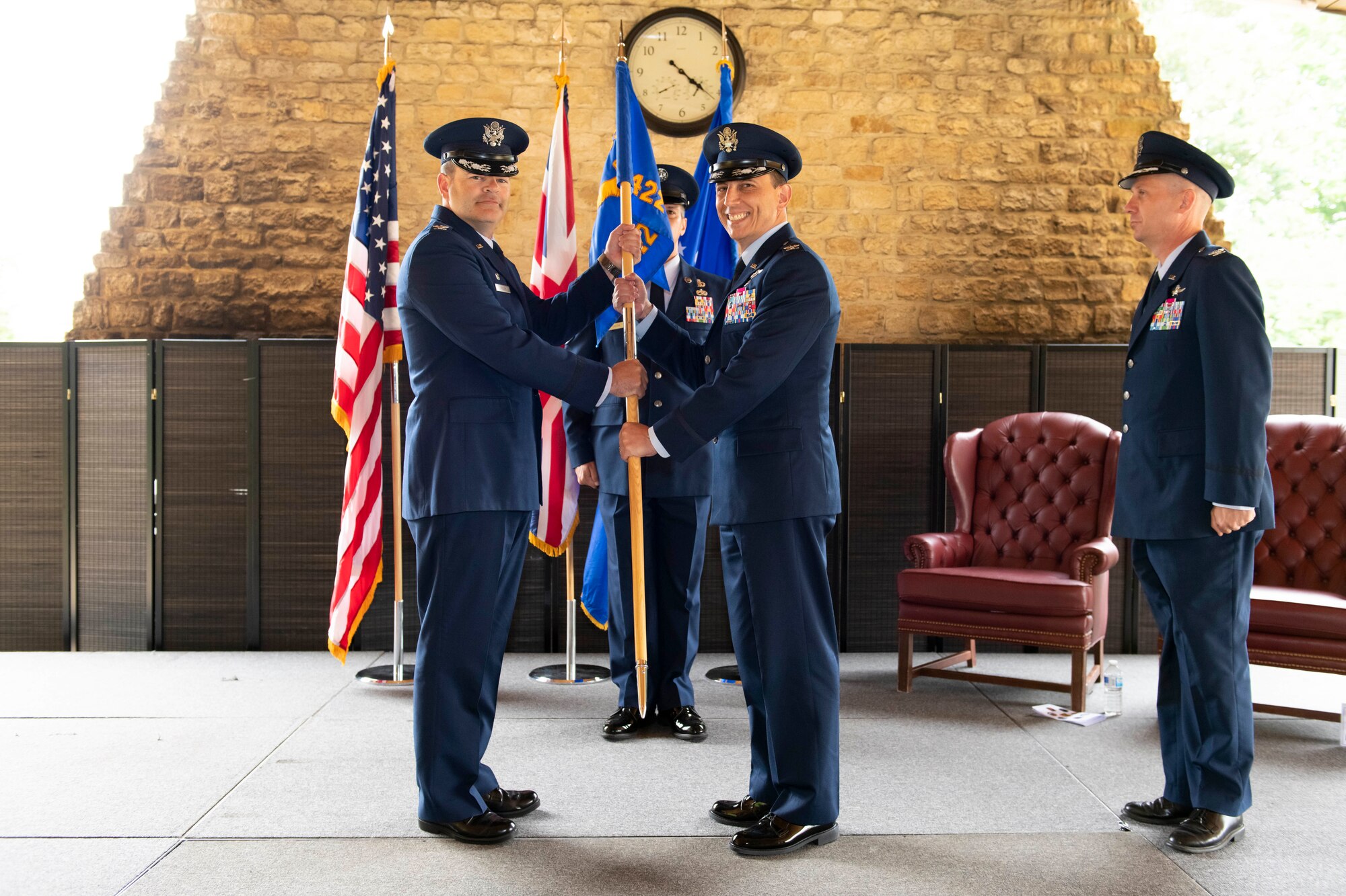 U.S. Air Force Col. Edward Spinelli, right, 422nd Air Base Group incoming commander, assumes command from Col. Brian Filler, left, 501st Combat Support Wing commander, during a change of command ceremony at RAF Croughton, England, July 20, 2022. The ceremony is a military tradition that represents a formal transfer of a unit’s authority and responsibility from one commander to another. (U.S. Air Force photo by Senior Airman Jennifer Zima)