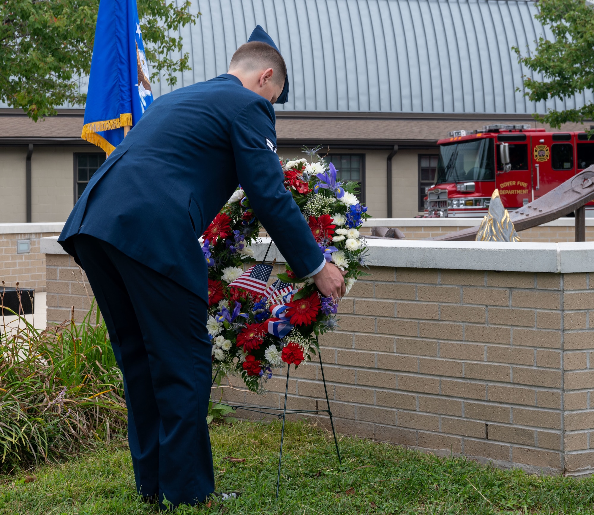 Airman 1st Class Carson Weiers, 436th Civil Engineer Squadron firefighter, places a wreath during the 21st Anniversary 9/11 Memorial Ceremony held at the Air Mobility Command Museum on Dover Air Force Base, Delaware, Sept. 11, 2022. The base hosted the ceremony to remember and honor those who perished in the attacks on Sept. 11, 2001. (U.S. Air Force photo by Senior Airman Cydney Lee)