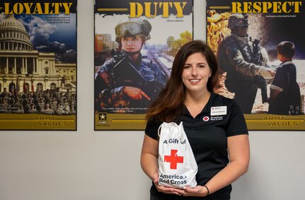 Sarah Houck, Services to the Armed Forces branch of the Red Cross, senior regional program specialist, displays a Red Cross gift bag at Joint Base Langley-Eustis, Virginia, Sept. 13, 2022
