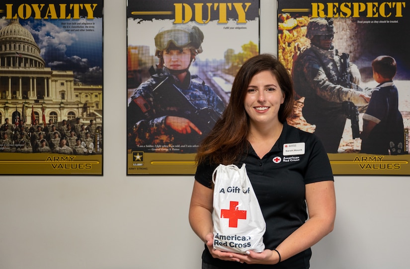Sarah Houck, Services to the Armed Forces branch of the Red Cross, senior regional program specialist, displays a Red Cross gift bag at Joint Base Langley-Eustis, Virginia, Sept. 13, 2022