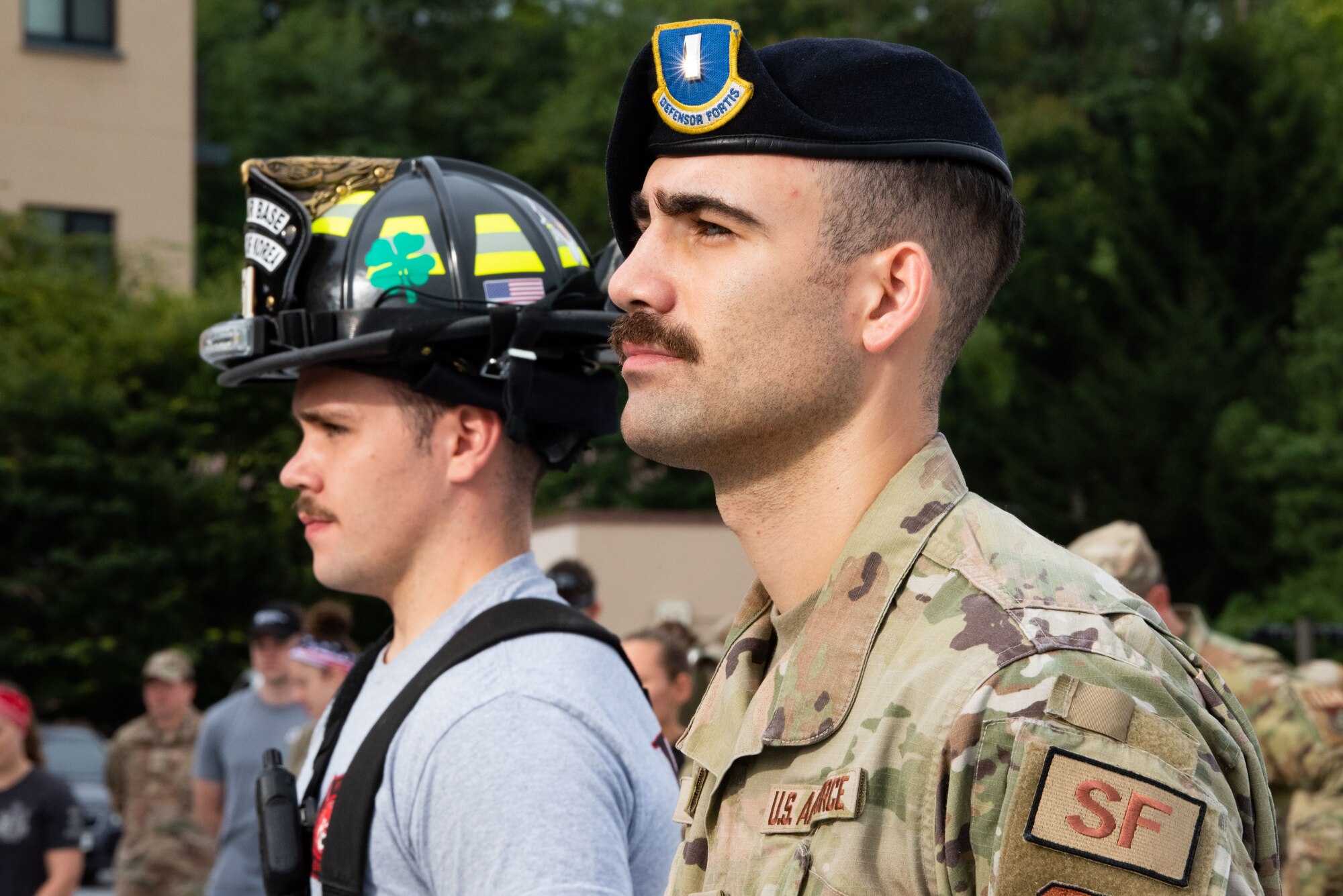 Senior Airman Corey McDonald, 51st Civil Engineer Squadron driver operator, and 1 Lt. Kyle Lunde, 51st Security Forces Squadron member, stand in formation during a 9/11 Remembrance Ceremony at Osan Air Base, Republic of Korea, Sept. 10, 2022.