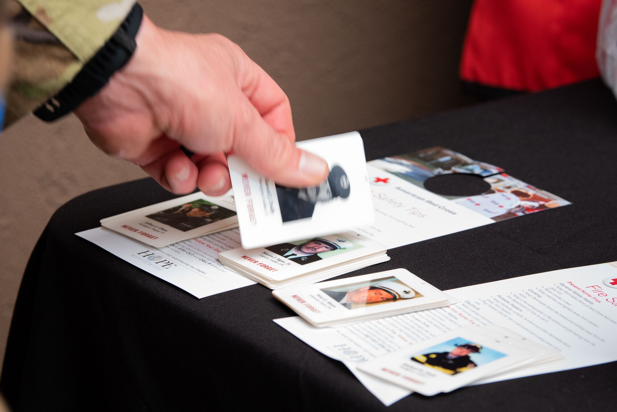 An Osan Airman grabs a first responder card during a 9/11 Remembrance Ceremony at Osan Air Base, Republic of Korea, Sept. 10, 2022.