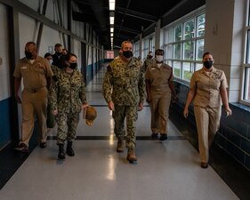 GREAT LAKES, Ill. (Aug. 25, 2022) Rear Adm. Pete Garvin, commander, Naval Education and Training Command (NETC), center, is escorted through USS Pearl Harbor during a visit to Recruit Training Command (RTC) Great Lakes, Illinois, Aug. 25, 2022. As part of his three-day visit, Garvin engaged with RTC recruit division commanders and Sailors, while observing various phases of boot camp and speaking at a graduation for 909 of the Navy’s newest Sailors.  As the owner of the Force Development pillar within MyNavy HR, Garvin leads the NETC mission to recruit, train and deliver those who serve the nation, taking them from “street to fleet” by transforming civilians into highly skilled, operational and combat ready warfighters. (U.S. Navy photo by Mass Communication Specialist 2nd Class Christopher M. O’Grady)