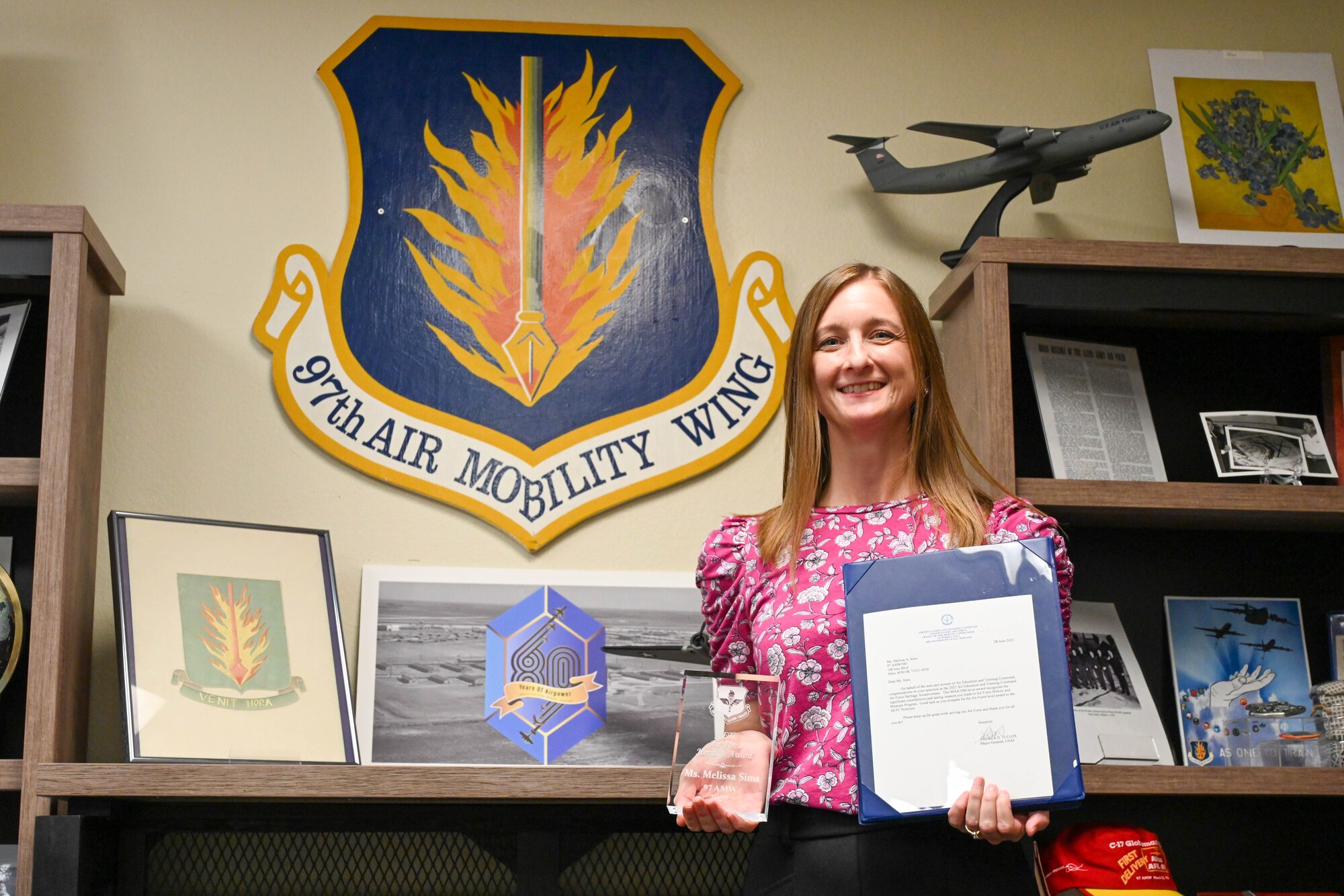 Melissa Sims, 97th Air Mobility Wing historian, poses for a photo at Altus Air Force Base, Oklahoma, Sept. 12, 2022. Sims was awarded the Air Education and Training Command Air Force Heritage Award for outstanding performance throughout the wing. (U.S. Air Force photo by Senior Airman Trenton Jancze)