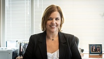 picture of Katherine MacKenzie sitting at desk.