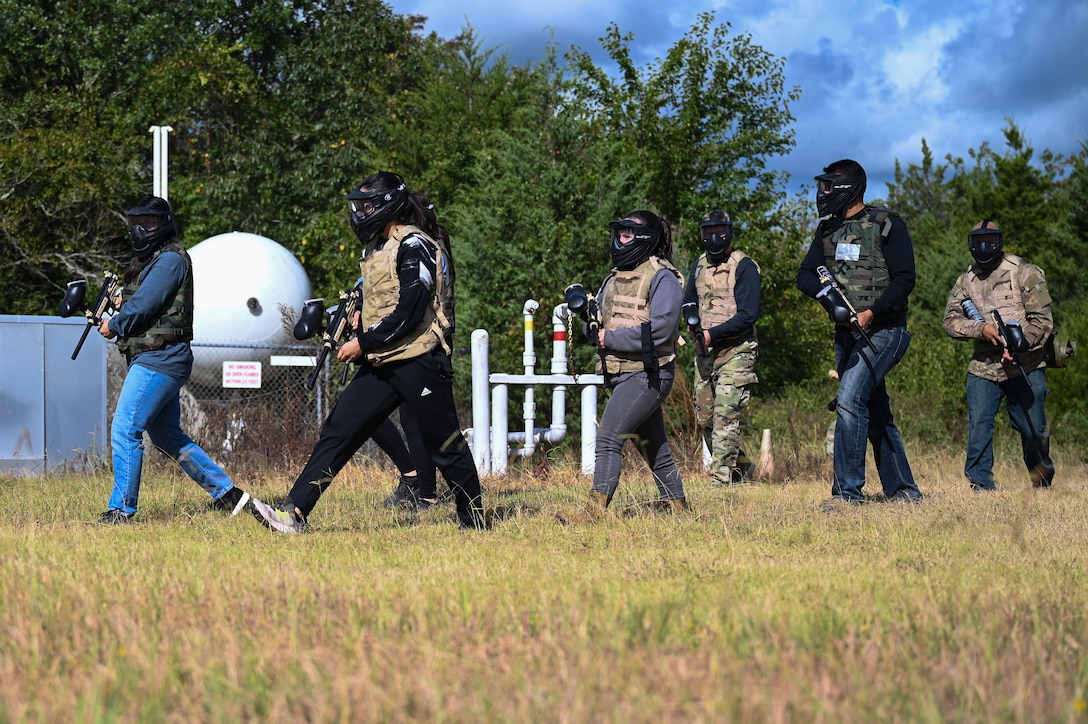 A group of airmen walking across a field.