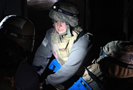 Airman talks to coworker during training exercise.