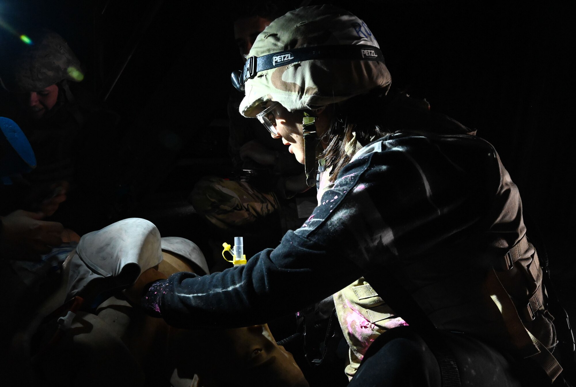 Airman monitors the pulse of medical mannequin.
