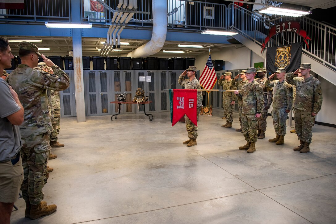 U.S. Army divers of the 511th Engineer Dive Detachment render honors during a pre-deployment ceremony at Joint Base Langley-Eustis, Virginia, September 9, 2022.