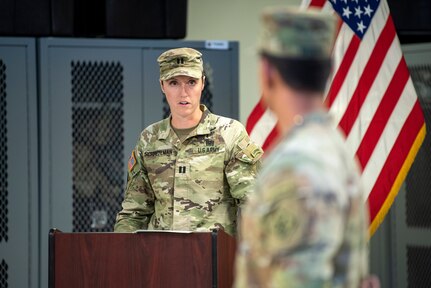 U.S. Army Capt. Olivia Schretzman, 511th Engineer Dive Detachment commander, delivers remarks to 1st Lt. Adriel Moran, 511th Engineer Dive Detachment executive officer, during a pre-deployment ceremony at Joint Base Langley-Eustis, Virginia, September 9, 2022.