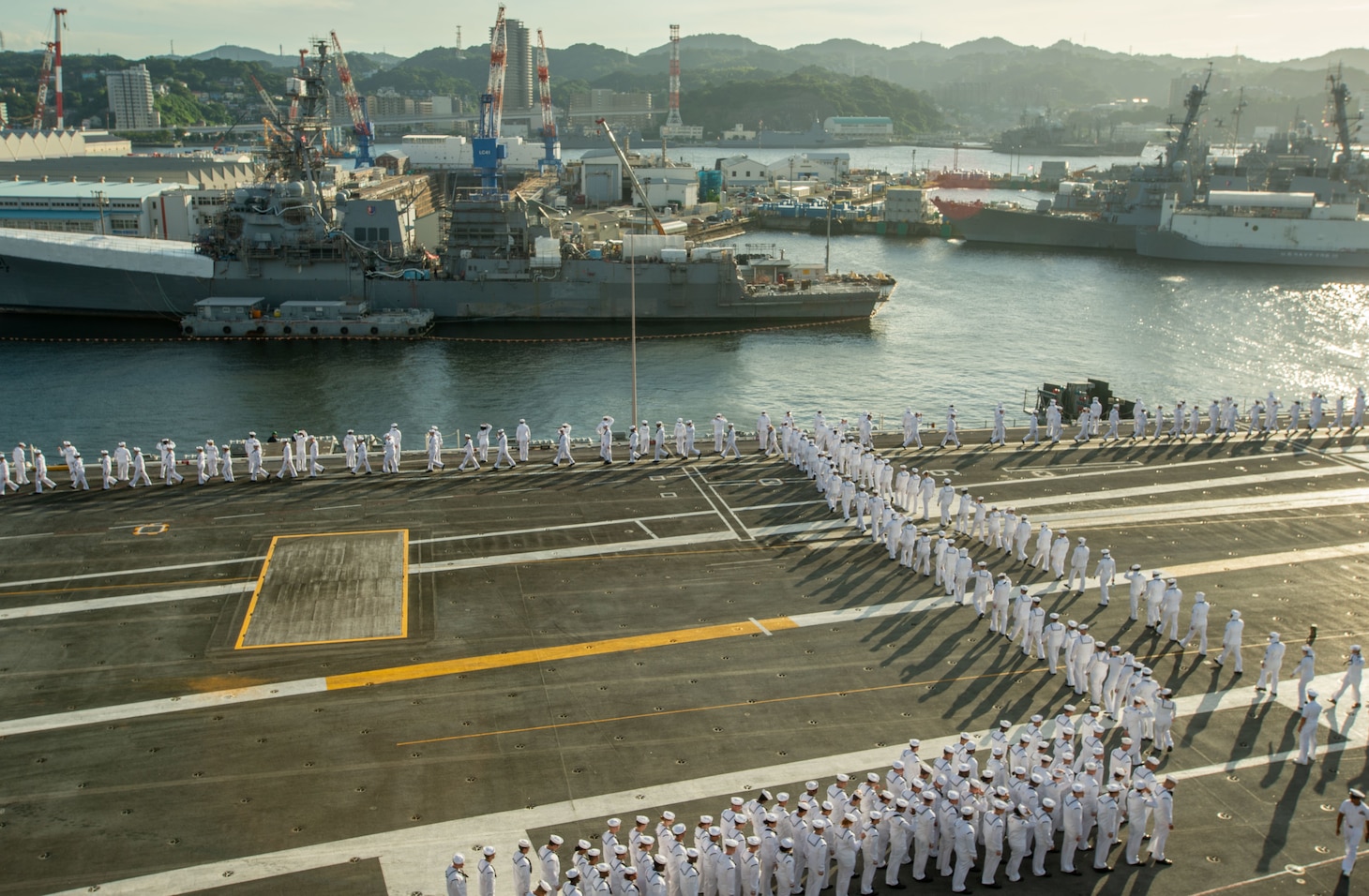 220912-N-JO823-1021 YOKOSUKA, Japan (Sept. 12, 2022) Sailors man the rails aboard the U.S. Navy’s only forward-deployed aircraft carrier, USS Ronald Reagan (CVN 76), as the ship departs Commander, Fleet Activities Yokosuka, Sept. 12. Ronald Reagan, the flagship of Carrier Strike Group 5, provides a combat-ready force that protects and defends the United States, and supports alliances, partnerships and collective maritime interests in the Indo-Pacific region. (U.S. Navy photo by Mass Communication Specialist Seaman Natasha ChevalierLosada)