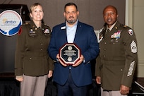 Col. Paige M. Jennings, U.S. Army Financial Management Command commander, and Command Sgt. Maj. Kenneth F. Law, USAFMCOM senior enlisted advisor, right, present Fernando Fernandez, Fort Hood National Bank vice president of military banking, with the Army Distinguished Bank Service Award in Washington, D.C., Aug. 30, 2022. USAFMCOM presented the award on behalf of the Office of the Assistant Secretary of the Army for Financial Management and Comptroller to recognize and strengthen the critical partnership between the Army and civilian financial institutions serving Soldiers and their families. (Photo by Tahnee Blauser)