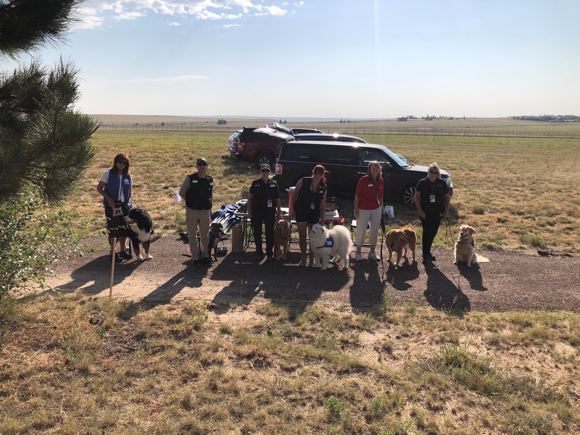 Volunteers from the American Red Cross gather for a group photo with their dogs during "Ruck 4 A Reason," a Suicide Prevention and Awareness Month event hosted at Peterson Space Force Base, Colo., Sept. 9, 2022.