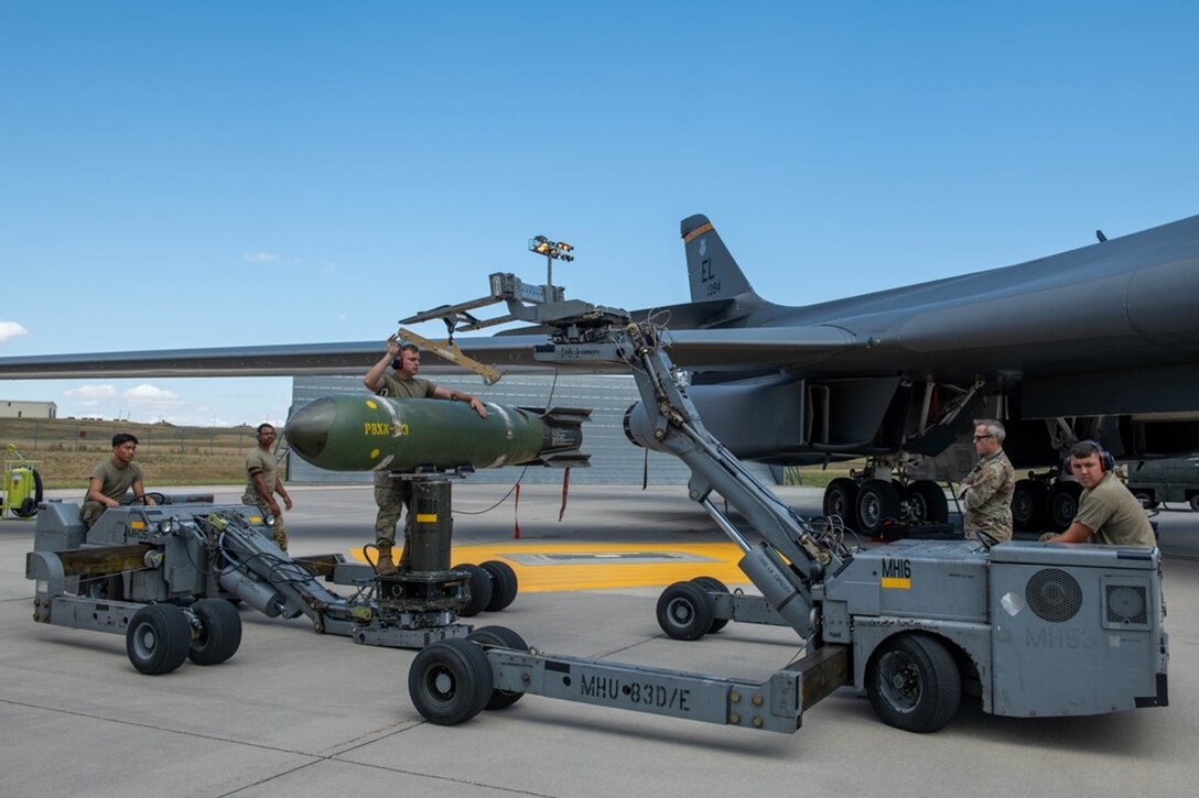 Load crew members from the 28th Aircraft Maintenance Squadron transport a Mark-65 Quickstrike mine at Ellsworth Air Force Base, S.D., Aug. 24, 2022. The Quickstrike is a family of shallow-water, aircraft-laid mines and the Mark-65 is a 2,000-pound mine used against surface and subsurface craft. (U.S. Air Force photo by Senior Airman Quentin K. Marx)