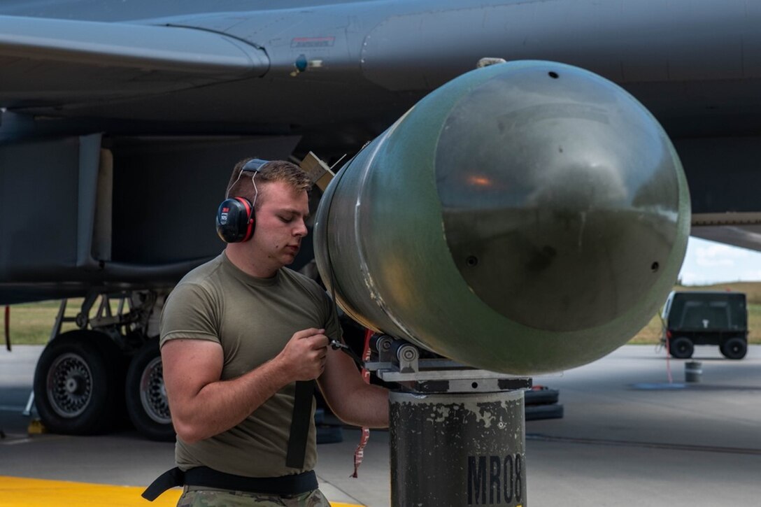 Senior Airman Lenny Taho, 28th Aircraft Maintenance Squadron load crew member, secures a Mark-65 Quickstrike mine to a munitions lift at Ellsworth Air Force Base, S.D., Aug. 24, 2022. B-1B Lancers can rapidly deploy more than seven Mark-65s. (U.S. Air Force photo by Senior Airman Quentin K. Marx)