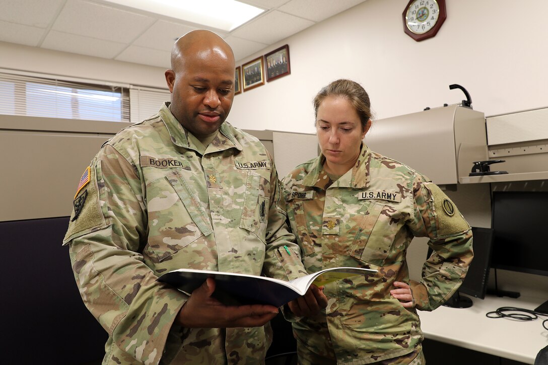Maj. Timothy Booker, left, and Maj. Rebecca Spohr look over a document at the 85th U.S Army Reserve Support Command’s Inspector General office, September 11, 2022.