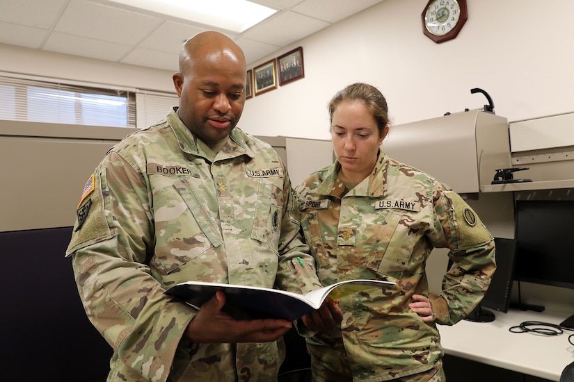 Maj. Timothy Booker, left, and Maj. Rebecca Spohr look over a document at the 85th U.S Army Reserve Support Command’s Inspector General office, September 11, 2022.