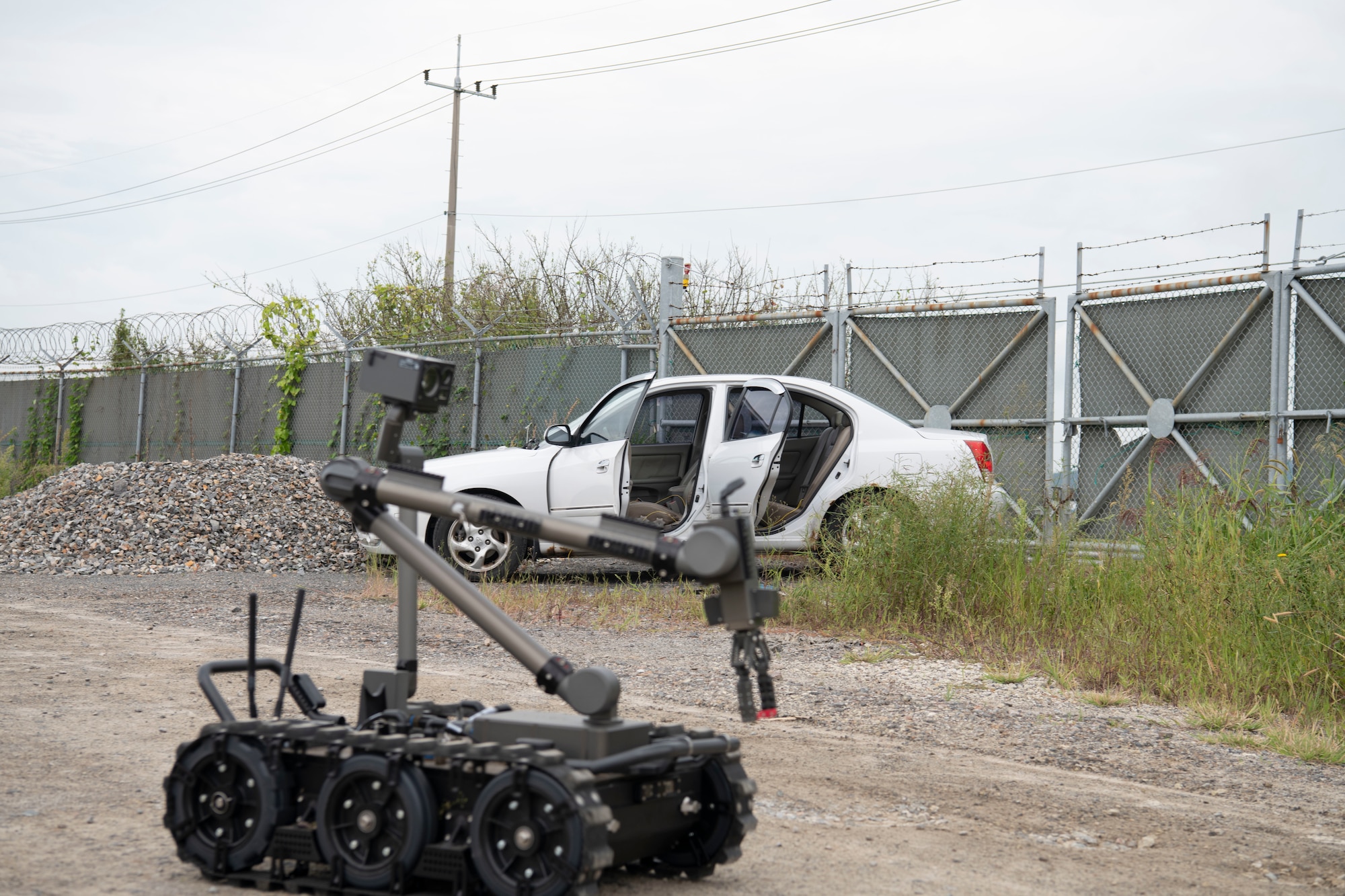 An 8th Civil Engineer Squadron explosive ordnance disposal (EOD) Man Transportable Robotic System approaches a simulated vehicle-borne improvised explosive (VBIED) device during a training event at Kunsan Air Base, Republic of Korea, Sept. 12, 2022. During the training scenario, personnel located a command operated VBIED, which was successfully disarmed by the EOD technicians. (U.S. Air Force photo by Staff Sgt. Sadie Colbert)