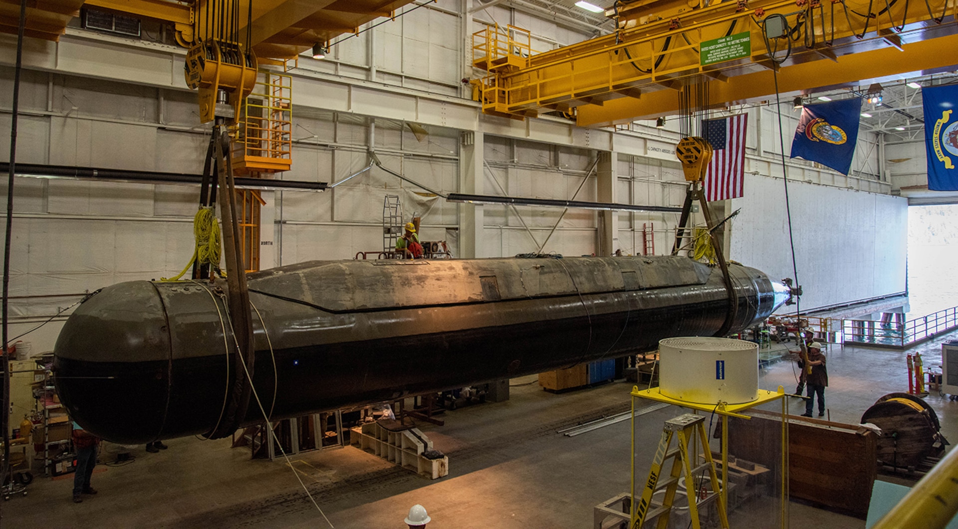 The Pike model, a scaled-size Columbia-class submarine model, is lifted from Lake Pend Oreille.