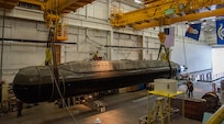 The Pike model, a scaled-size Columbia-class submarine model, is lifted from Lake Pend Oreille.