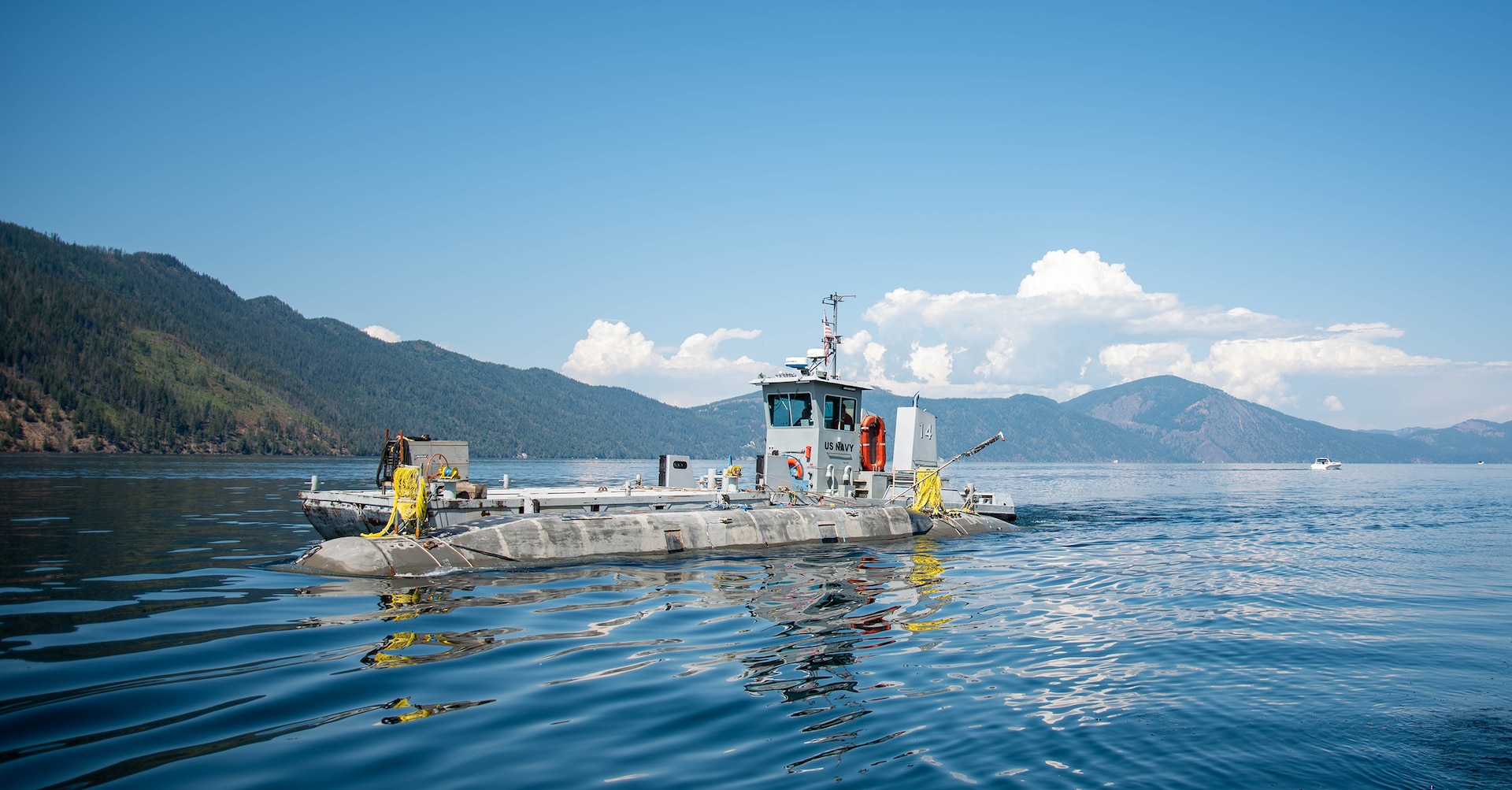 The Columbia-class submarine model Pike is tugged through the waters of Lake Pend Oreille.