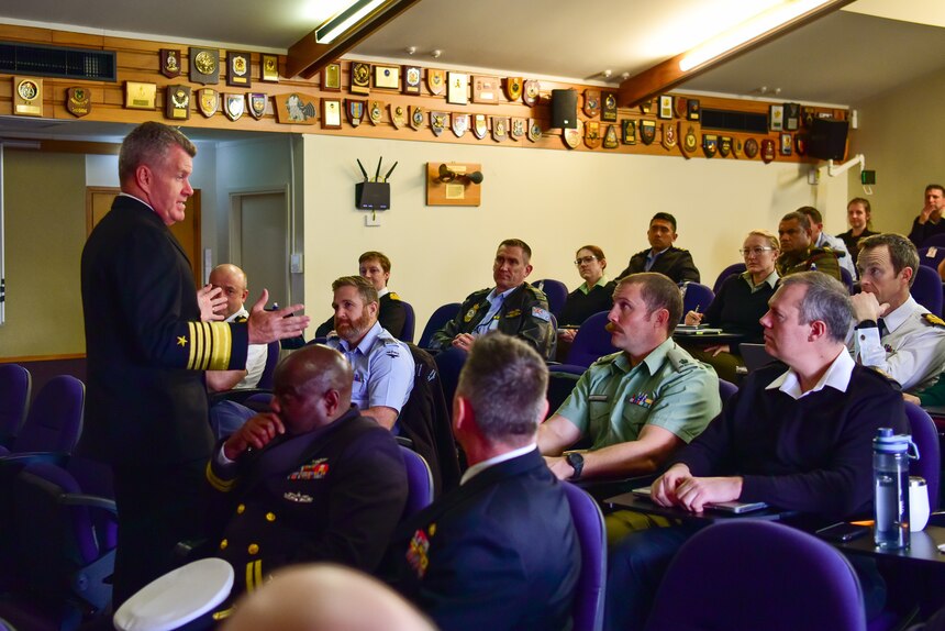 Adm. Samuel Paparo speaks with students at the New Zealand Command and Staff College.