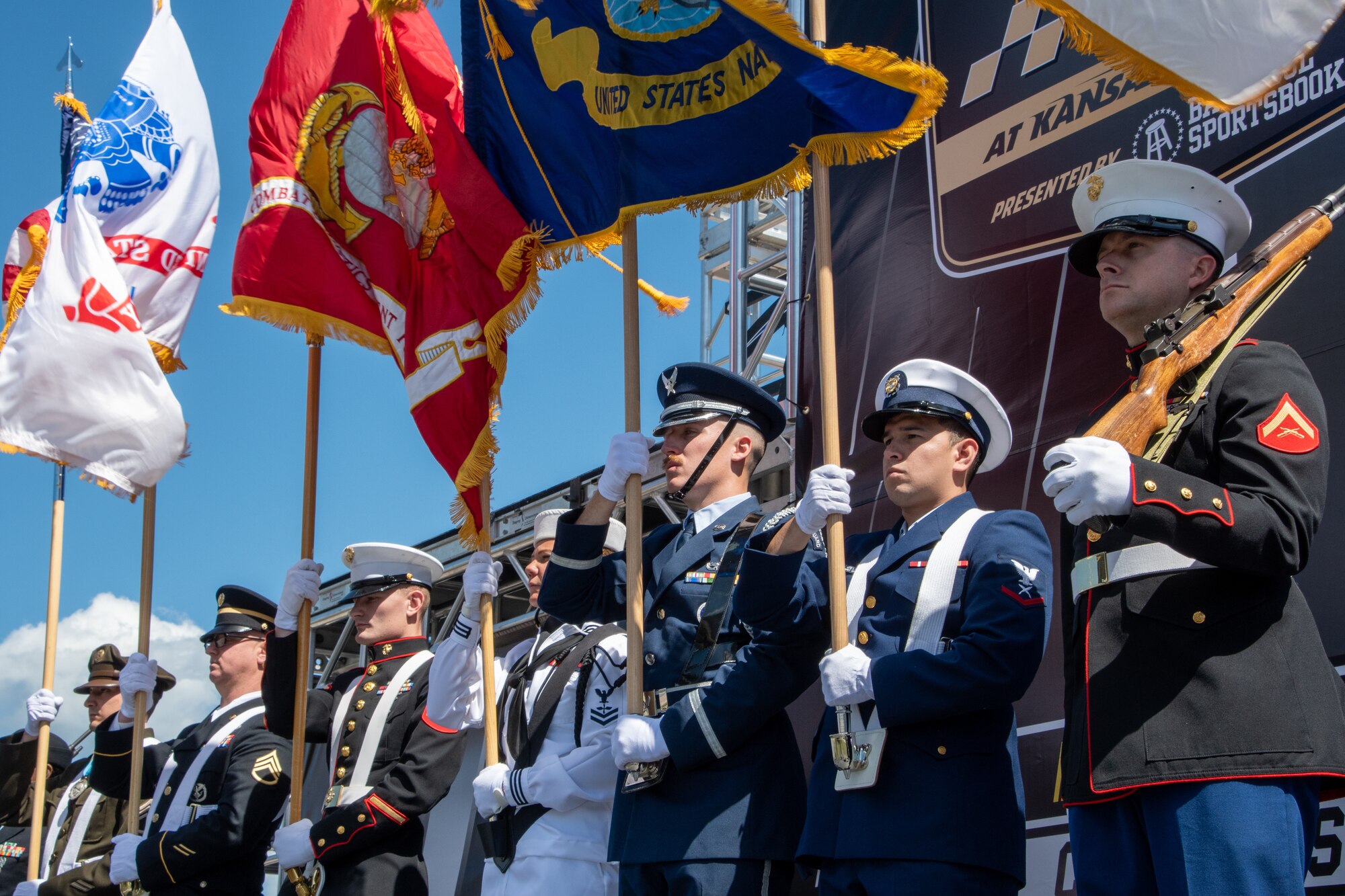 A Joint Color Guard prepares to present the colors for the National Anthem at the NASCAR Hollywood Casino 400 at the Kansas Speedway in Kansas City, Kansas, Sept. 11, 2022. Whiteman Air Force Base Airmen supported pre-race festivities to represent the U.S. Air Force. (U.S. Air National Guard photo by Airman 1st Class Phoenix Lietch)