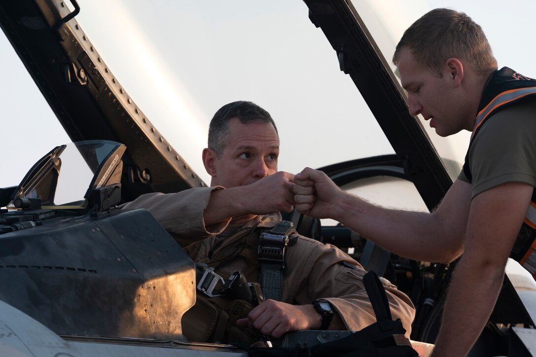 U.S. Air Force Lt. Gen. Alexus Grynkewich, Ninth Air Force commander, thanks Senior Airman Tyler Collins, 79th Fighter Generation Squadron crew chief, prior to departure during an exercise at an Undisclosed Location, September 7, 2022. Crew chiefs will perform end-of-runway, postflight, preflight and thru-flight operations in any condition to ensure the mission is able to be accomplished. (U.S. Air Force photo by Staff Sgt. Dalton Williams)