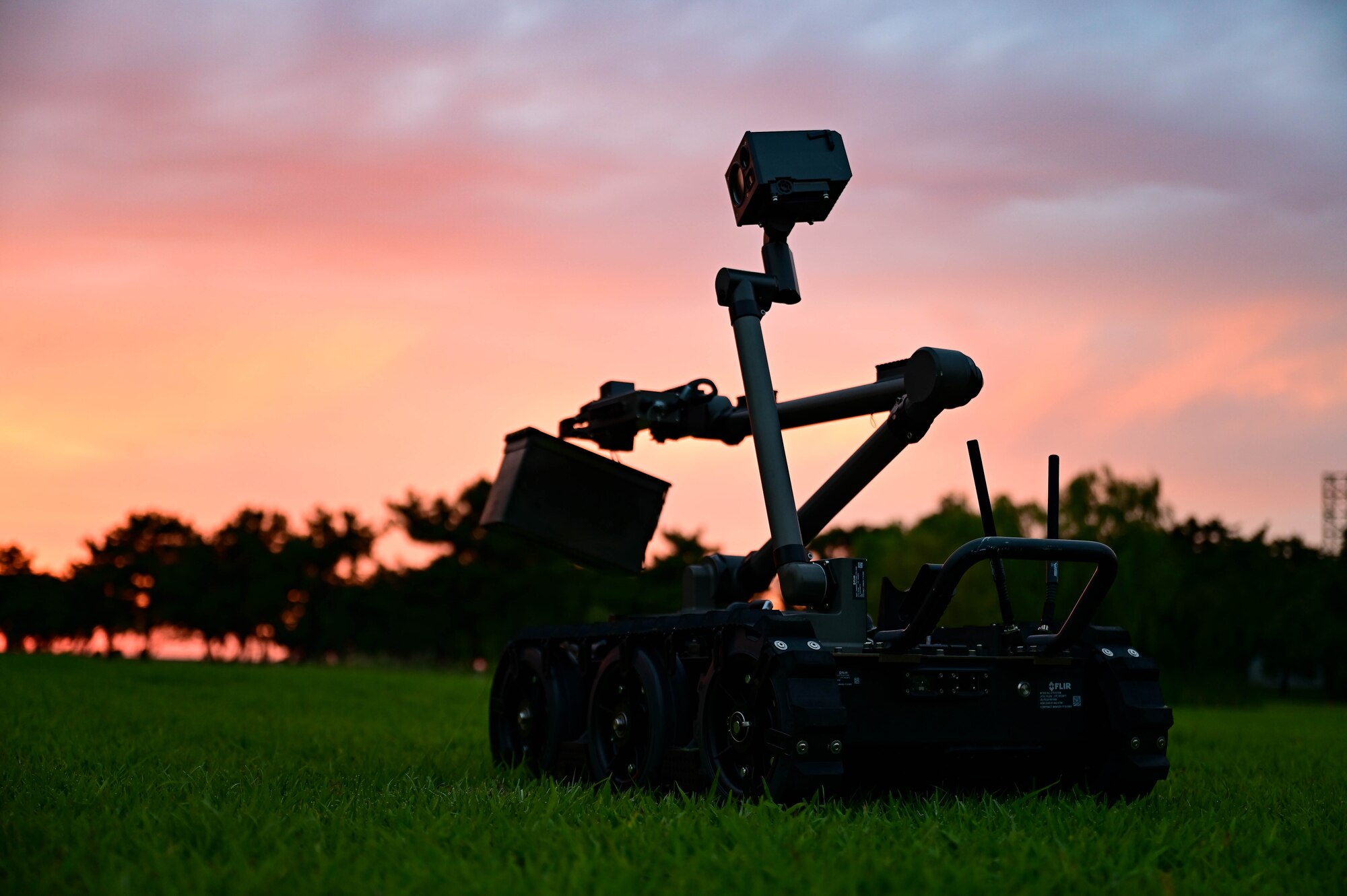 Explosive disposal robot with sunset.