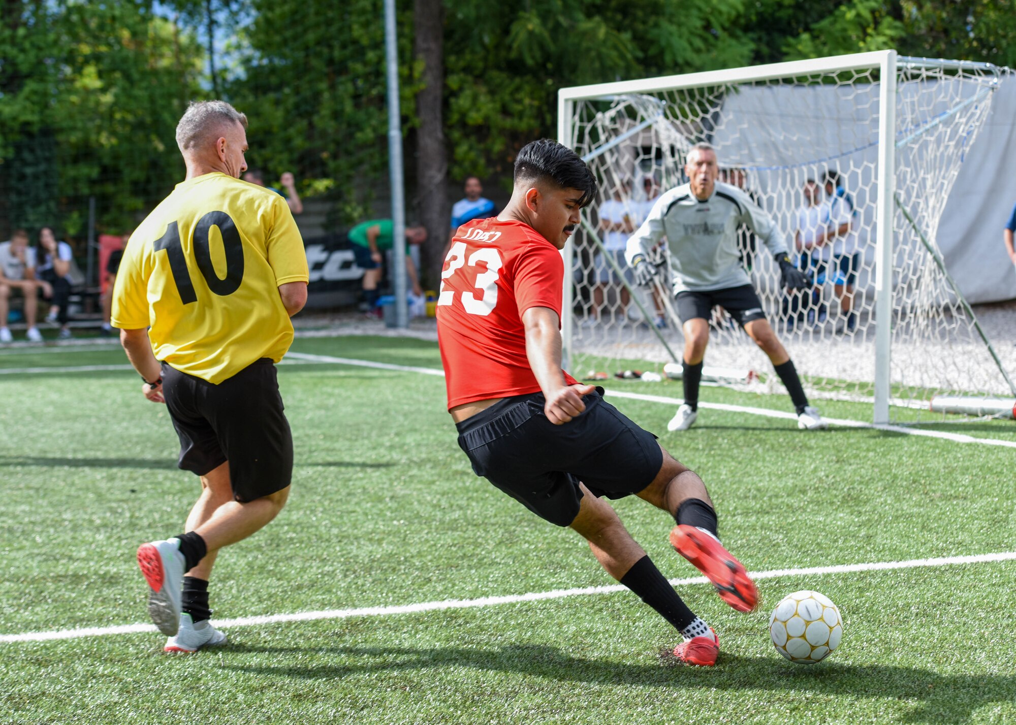 A U.S. Air Force member assigned to Aviano Air Base, right, competes in a soccer game with members of the local community during the 21st Annual Italian American Friendship Festival in Roveredo in Piano, Italy, Sept. 10, 2022. The Friendship Festival included sporting events in soccer, basketball and volleyball featuring players from both countries. (U.S. Air Force photo by Senior Airman Brooke Moeder)