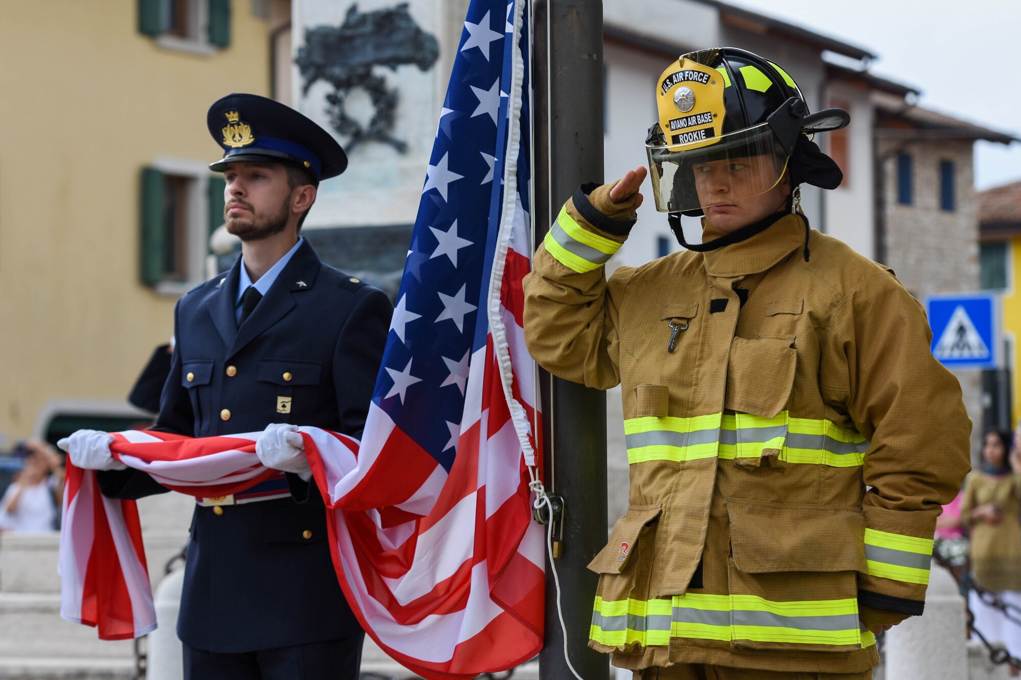 An Italian air force member assigned to the ITAF honor guard, left, and a U.S. Air Force Airman assigned to the 31st Civil Engineer Squadron Fire Department salute during the 21st Annual Italian-American Friendship Festival in Roveredo in Piano, Italy, Sept. 10, 2022. The 21st anniversary of the Friendship Festival represented a moment of solidarity and union between the Italian and American communities, in commemoration of the events of Sept. 11, 2001. (U.S. Air Force photo by Senior Airman Brooke Moeder)