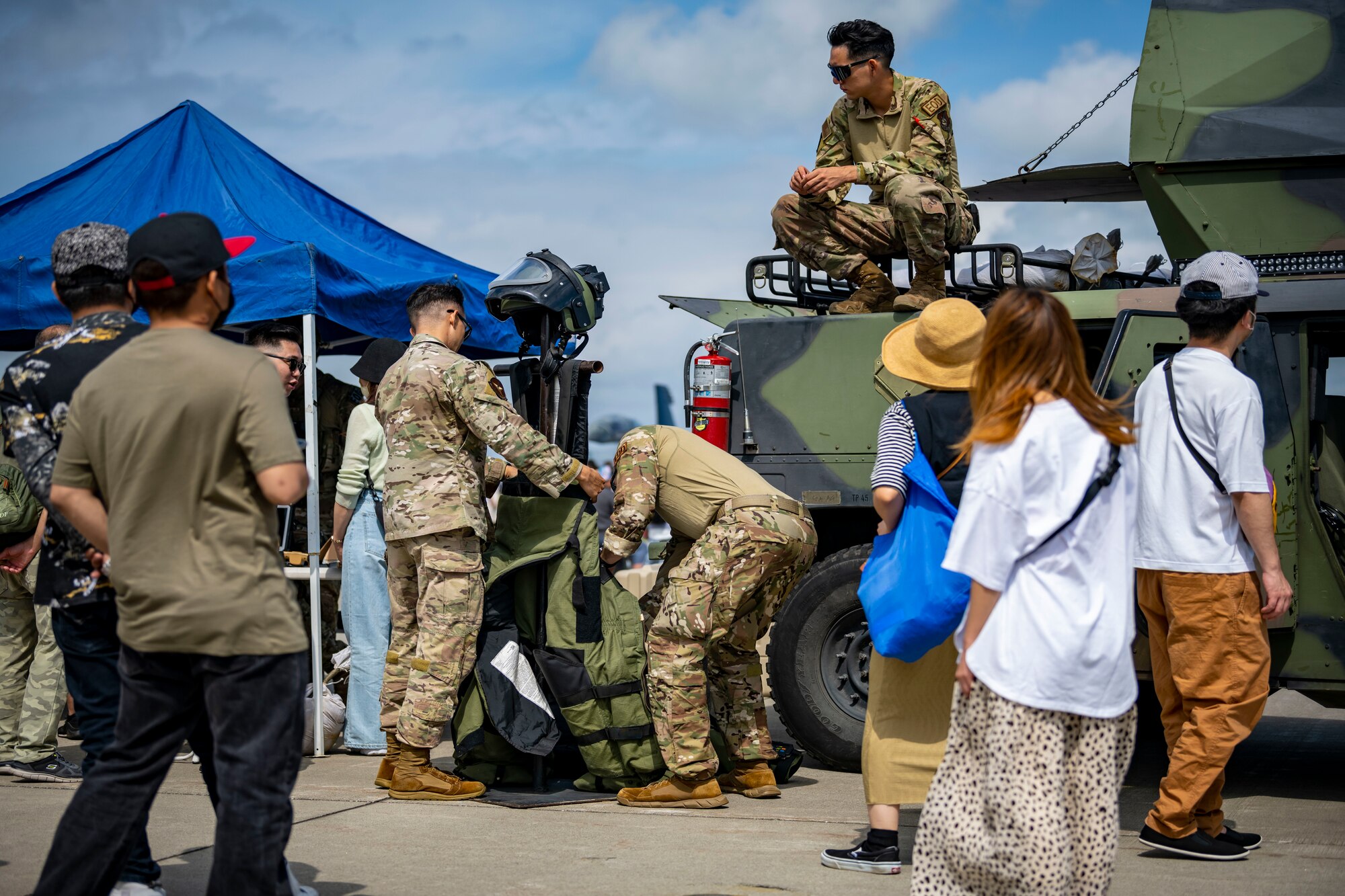 U.S. military members set up an EOD bomb suit on a mannequin.