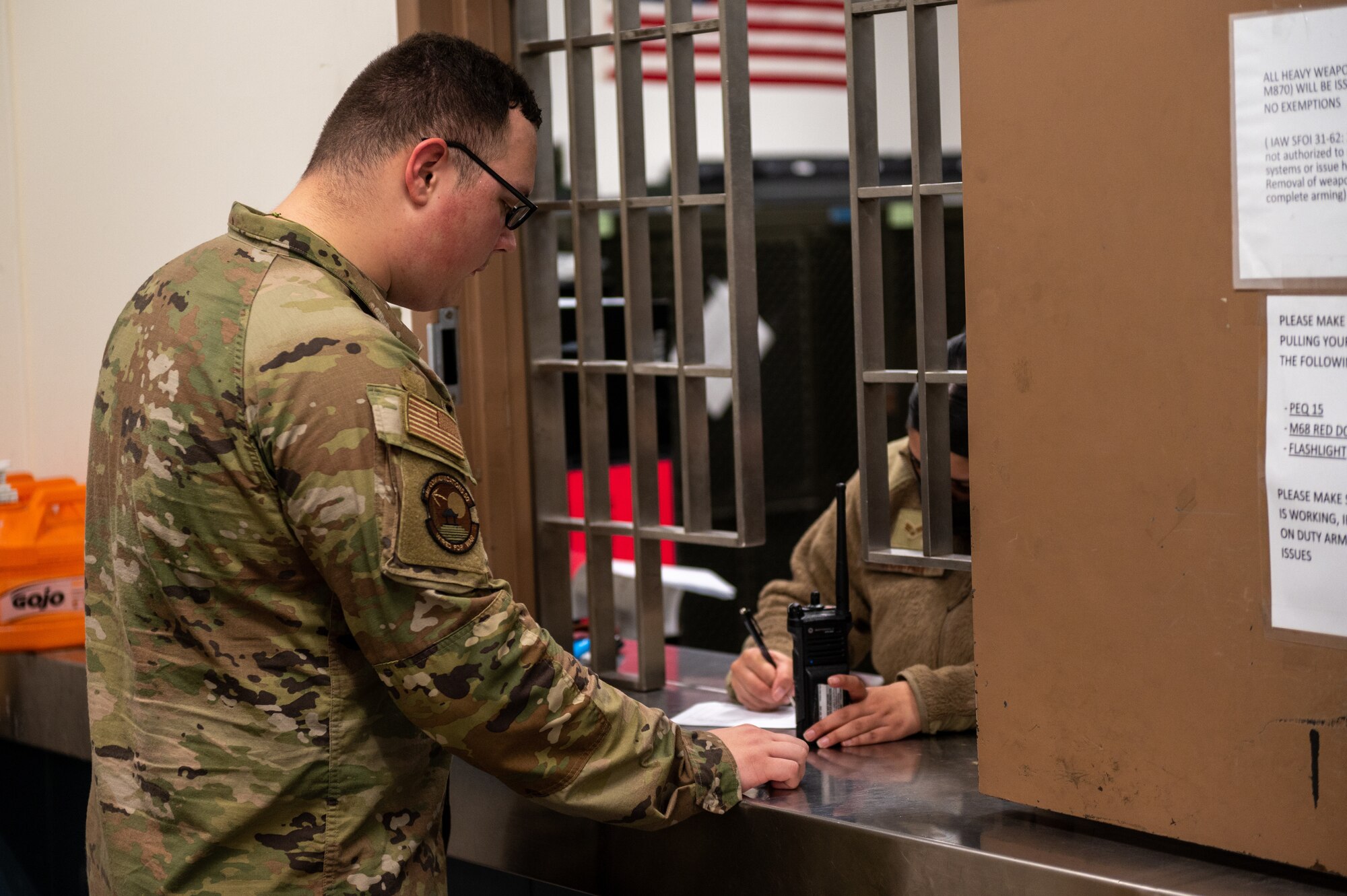 U.S. Air Force Senior Airman Raven Grove, 51st Communications Squadron network systems technician, receives a radio during an augmentee recall as part of a base-wide training event