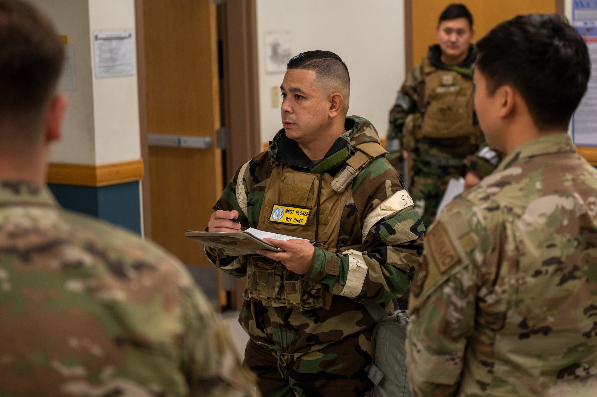 U.S. Air Force Master Sgt. Christopher Flores, 51st Security Forces Squadron wing inspection team chief, briefs security forces augmentees on their upcoming augmentee duties in support of a base-wide training event