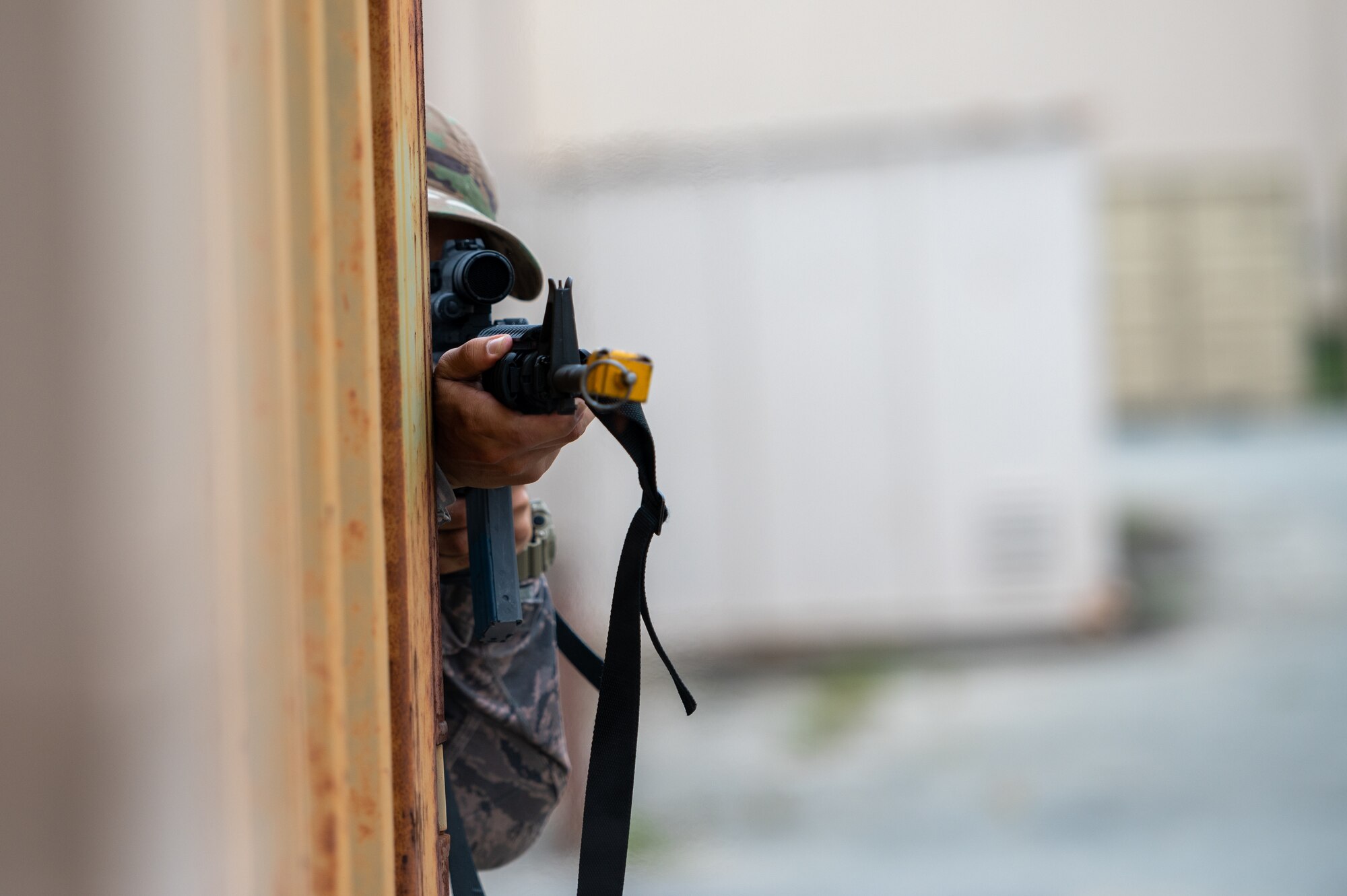 U.S. Air Force Airman 1st Class Marlon Perez, opposing forces (OPFOR), takes aim at 51st Security Forces Squadron defenders during a “Defend the Base” training scenario