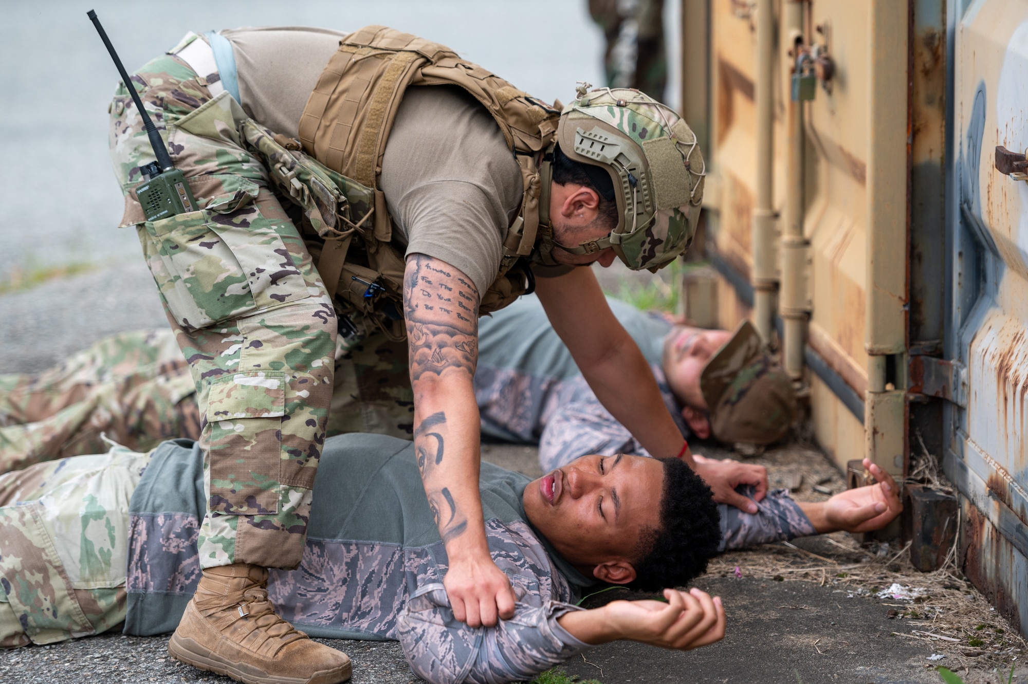 U.S. Air Force Senior Airman Angel Raymundo, 51st Security Forces Squadron defender, checks U.S. Air Force Airman 1st Class Nathan Beckham, opposing forces (OPFOR) member, for hidden weapons during a training event