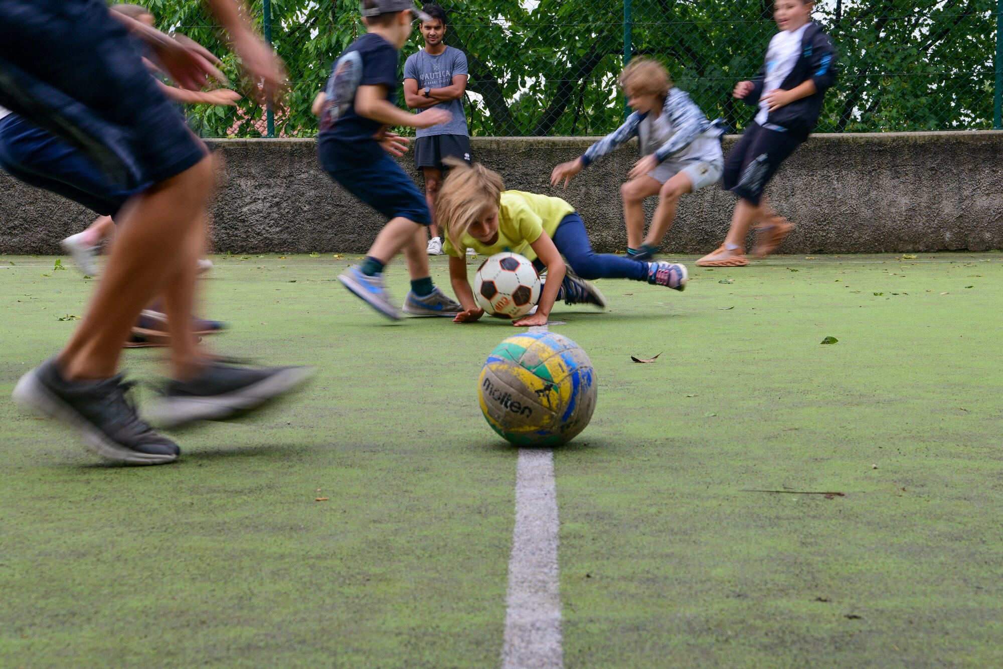 Local national children participate in dodgeball at the Giovani in Movimento summer camp in Aviano, Italy, Aug. 31, 2022. During the Vicini Americani English Teaching Program volunteers worked with children ranging from 6-14 years old. (U.S. Air Force photo by Senior Airman Brooke Moeder)