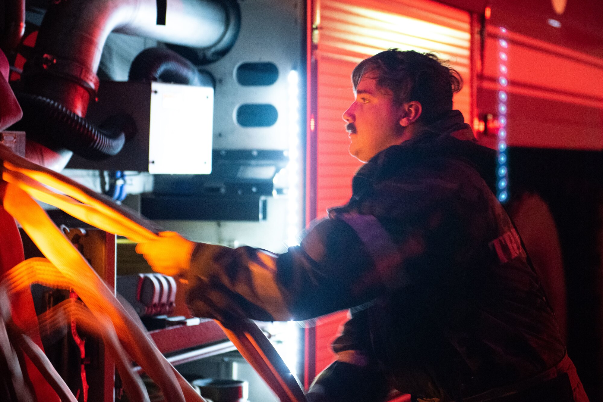 U.S. Air Force Senior Airman Jacob Jenkins, 51st Civil Engineer Squadron (CES) fire station driver and operator, pulls a hose from a fire truck during a fire response scenario at Osan Air Base, Republic of Korea, Sept. 12, 2022, in support of a wing training event.