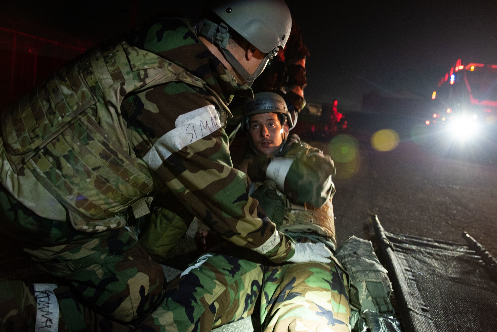 U.S. Air Force Airman Johnathan Rondon Cruz, 51st Civil Engineer Squadron firefighter, receives medical attention from a field response team member during a fire response scenario at Osan Air Base, Republic of Korea, Sept. 12, 2022, in support of a wing training event.