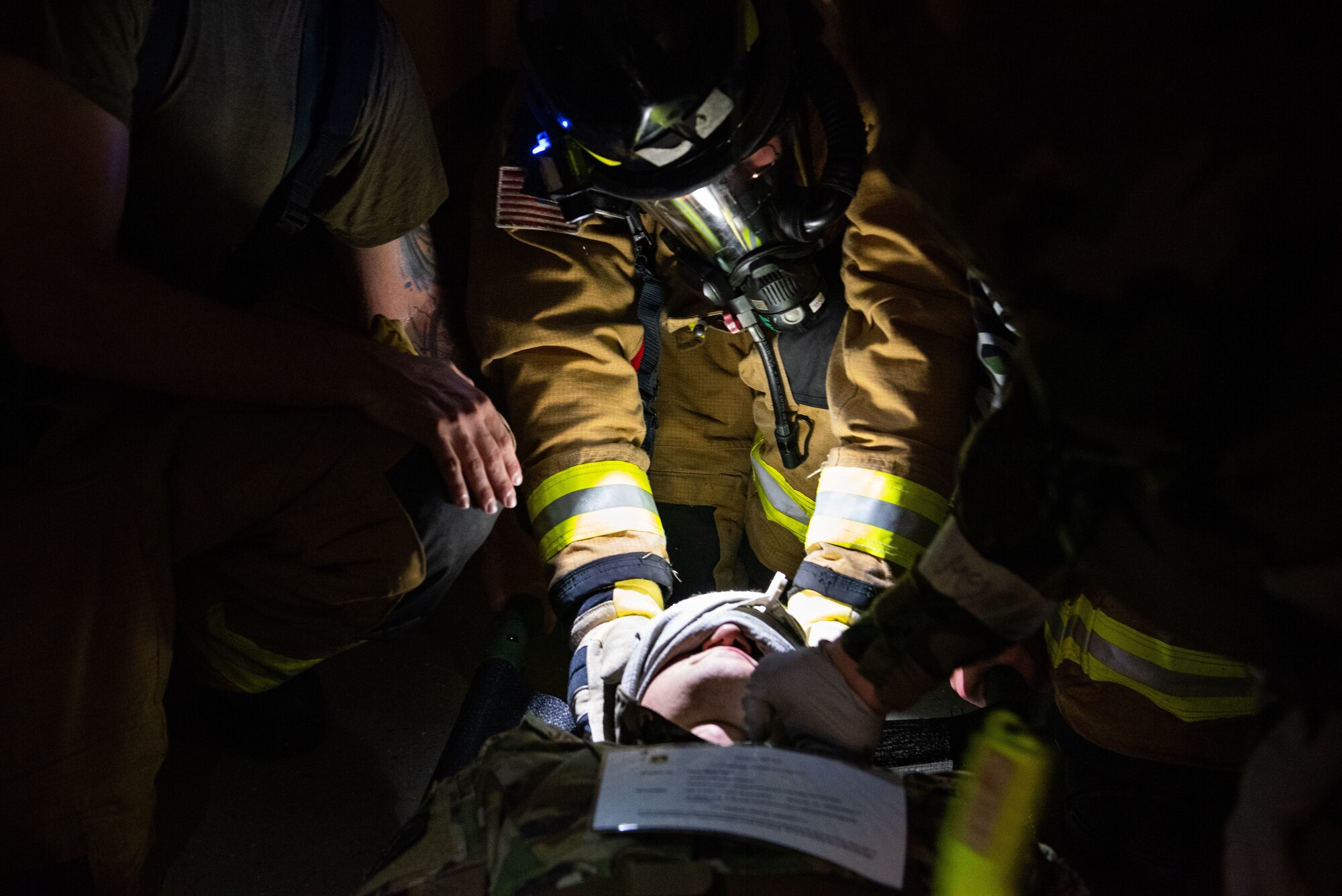 Firefighters assigned to the 51st Civil Engineer Squadron, treat a simulated injured Airman during a fire response scenario at Osan Air Base, Republic of Korea, Sept. 12, 2022, in support of a wing training event.