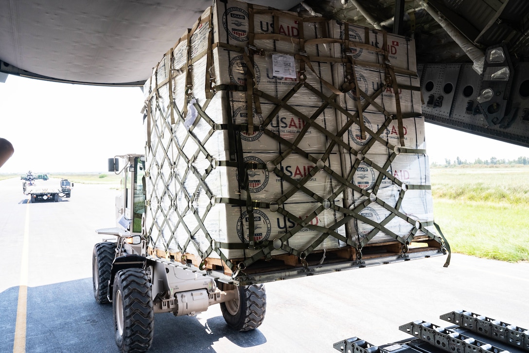 A forklift holds a pallet of equipment.