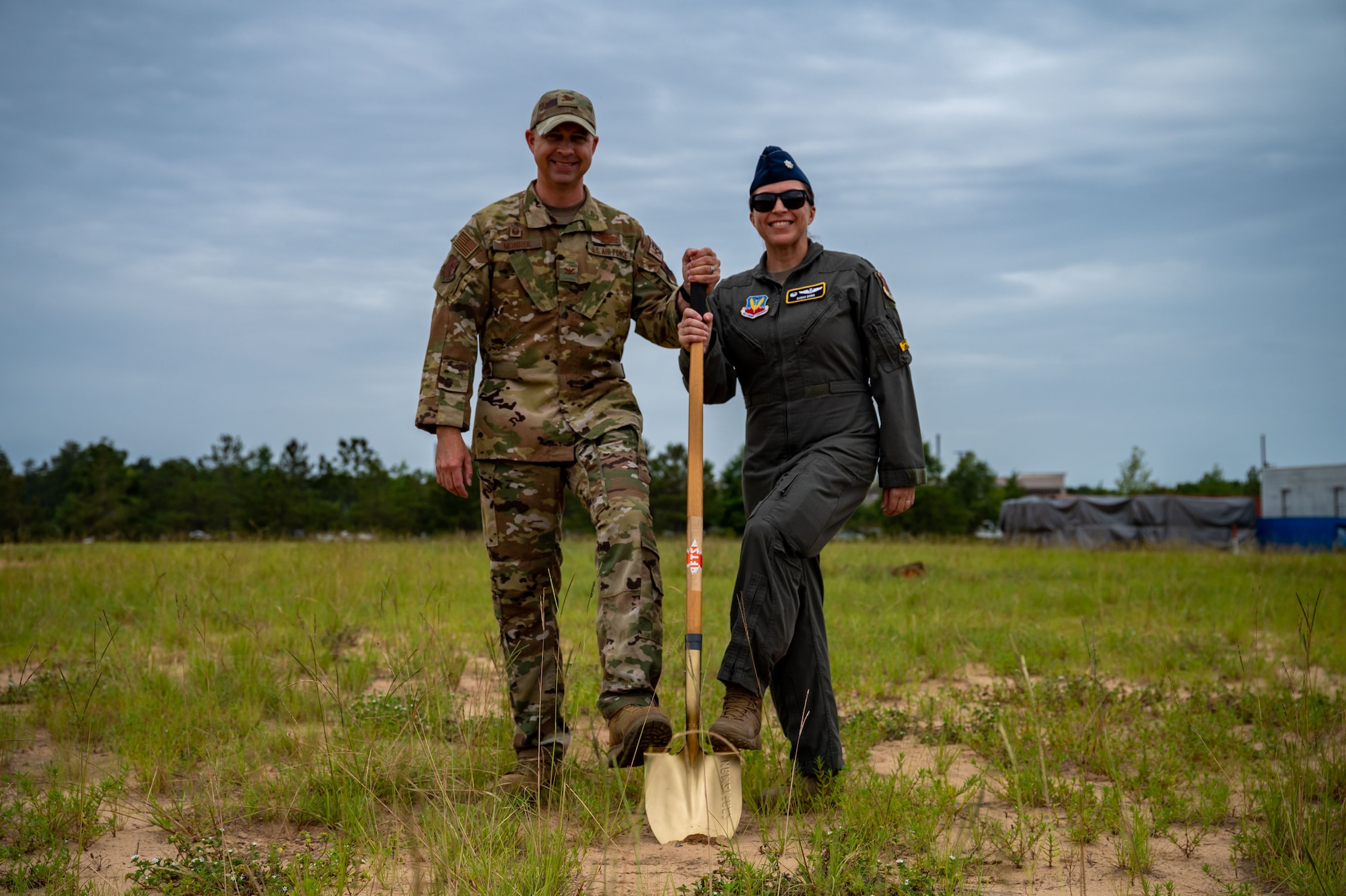 A photo of Airman outside holding a shovel.