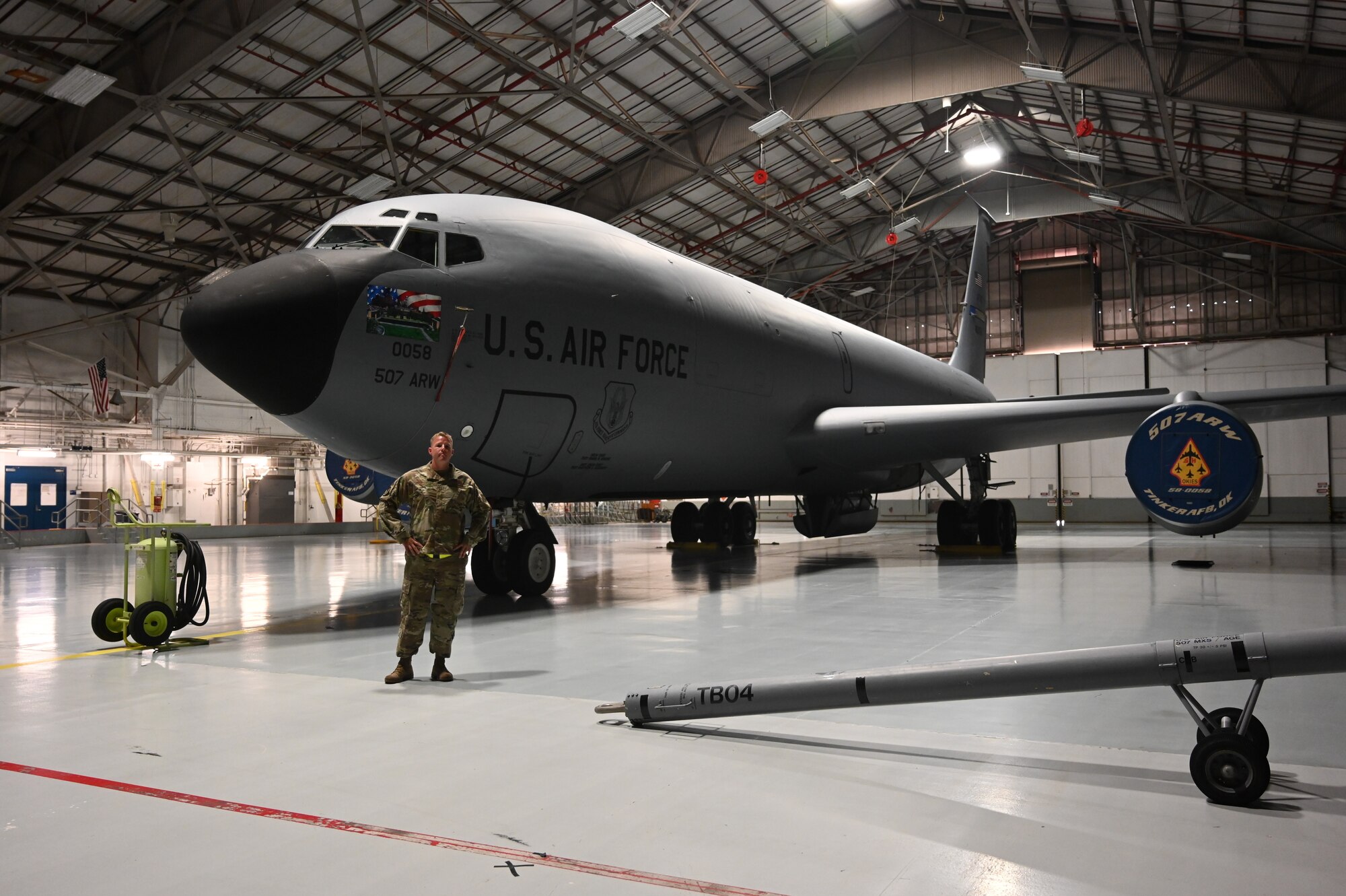 an airman standing in front of a plane