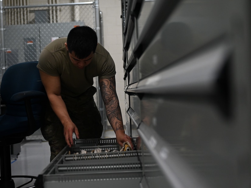 LO Airman prepares to paint an F-22