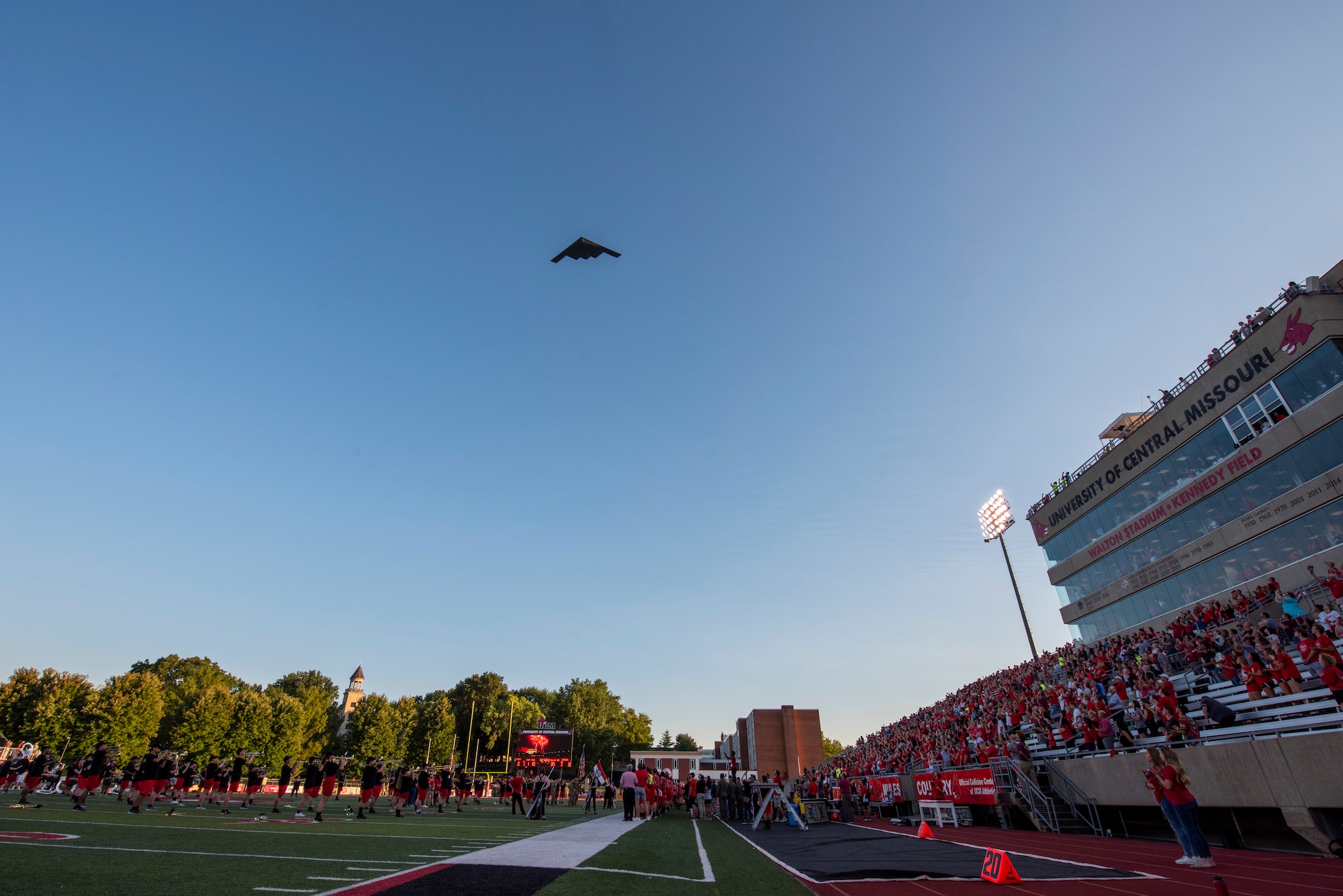 A B-2 Spirit from Whiteman Air Force Base, Missouri, performs a flyover prior to the University of Central Missouri Military Appreciation football game, Sept. 8, 2022, in Warrensburg, Missouri. Whiteman AFB and UCM share a valuable community partnership that fosters a supportive relationship between the base and local communities. (U.S. Air Force photo by Tech. Sgt. Dylan Nuckolls)